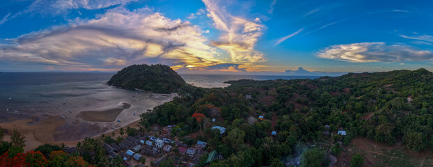 Panoramic sunset aerial of Sakatia Island, Nosy Be, Madagascar &ndash; golden light over the ocean, tropical coastline, and peaceful island landscape.