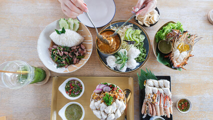 young women eating seafood in restaurant