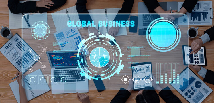 A group of professionals engaged in a modern business meeting around a table, showcasing digital analytics and financial data on various screens and devices. Trope - Powered by Adobe