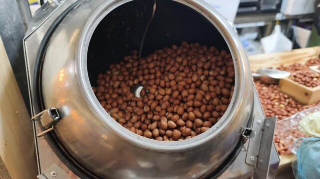 Metal roasters handle bulk production raw peanuts. Industrial nut processing machinery ensures consistent quality, large scale bulk production. Automated nut processing speeds up market supply.