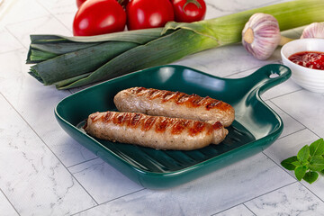 Grilled pork sausages served tomato sauce