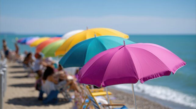 Row of colorful umbrellas are set up on a beach. There are several people sitting under the umbrellas, enjoying the sun and the view of the ocean