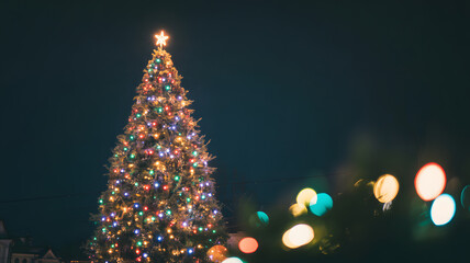 Illuminated christmas tree at night with bokeh lights