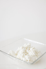 Fresh cottage cheese in glass bowl on white background for cookbook