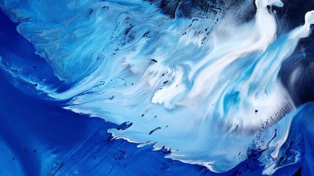 Macro video of flowing blue and white paint resembling waves