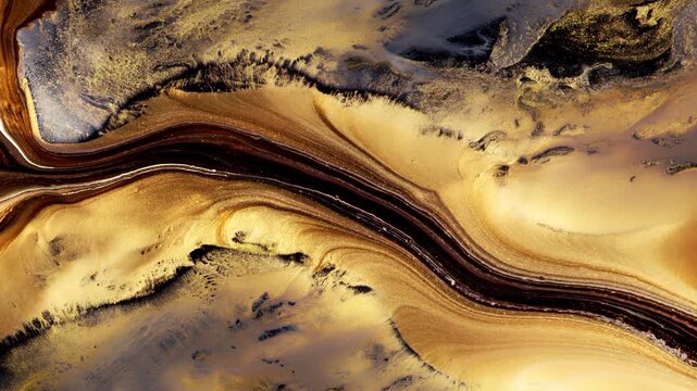 Macro video of flowing gold brown and black paint agate texture