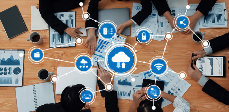 A top view of a business meeting focused on cloud computing strategy, featuring charts and data analysis, exemplifying teamwork and innovation in a professional setting. Amity - Powered by Adobe
