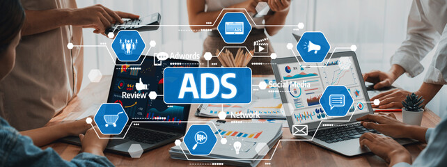A dynamic business team collaborating on digital marketing strategies. Multiple laptops display charts and ads, showcasing innovative approaches to enhance advertising campaigns. Amity