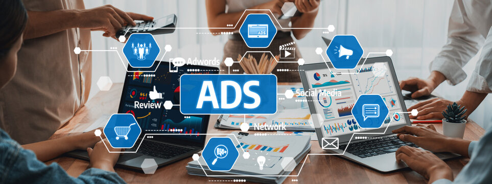 A dynamic business team collaborating on digital marketing strategies. Multiple laptops display charts and ads, showcasing innovative approaches to enhance advertising campaigns. Amity - Powered by Adobe