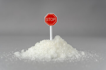 Stop Sugar Warning Concept with Spoon and Granulated Sugar