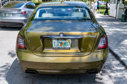 Miami, Florida, USA - April 18, 2025: Car 2024 Rolls Royce Ghost parked outdoor. Golden car, corner view. 2024 Rolls Royce Ghost sedan car. Luxury sedan car Rolls Royce Ghost.