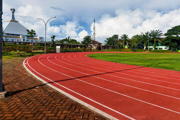Running track above the blue sky and clouds