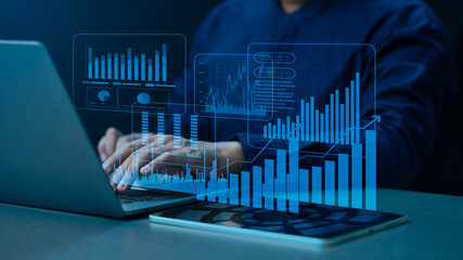 Executive monitoring corporate growth projection and financial market performance using innovative AI-powered analysis platform with dynamic virtual data dashboard on laptop.
