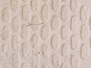 Close-up abstract background of pale cream textured concrete wall with diagonal cross pattern design element