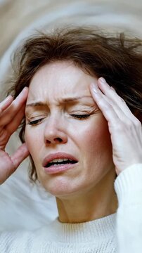 Woman endures agonizing head pain, a critical symptom of potential brain health issues, including serious cerebrovascular events or transient ischemic attack.