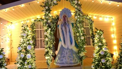 Enchanting winter scene with Granddaughter Snegurochka calls Santa Claus at the decorated winter house