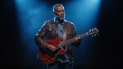 Playing electric guitar on stage. Guitarist plays blues music under spotlight. Solo performance captures live emotion and focus. Concert atmosphere feels intimate and dramatic. Crowd reacts strongly.