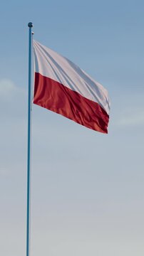 Poland, Warsaw: Cinematic Vertical Waving National Flag Against Blue Sky