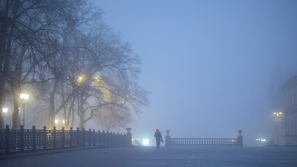 A foggy city in the light of street lamps. Minsk