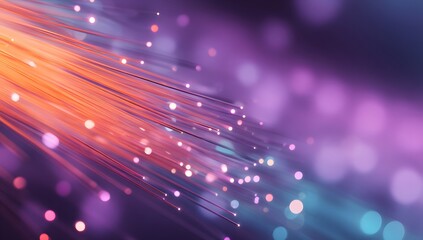Abstract close up of glowing orange fiber optic strands illuminated against a bokeh background of purple and blue light effects