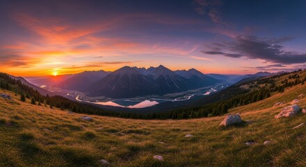 Majestic mountain valley at sunset with vibrant sky