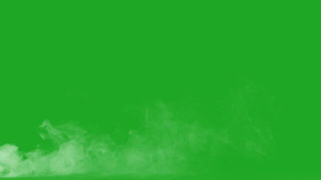 swirling smoke rolling low across the ground. green screen smoke effect.