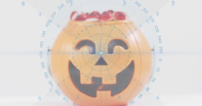 Displaying orange pumpkin bucket sitting on pale table, showing red candy and blue radar overlay