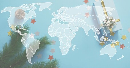 Displaying white world map outline across blue sheet showing pine branch, gift box, gold confetti