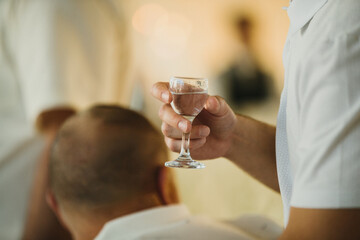 Man holding small glass for a celebration toast
