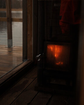 cosy burning log fired floating sauna in winter in Sweden
