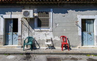 Green, white and red colored chairs form the Italian flag on the street in Catania, Italy