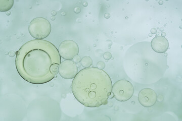 A macro abstract image of oil bubbles suspended in clear liquid, evoking facial serum texture. Ideal for beauty, cosmetic, and skincare-themed visuals.