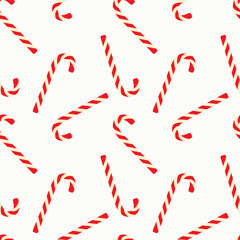 Christmas candy cane seamless pattern with red and yellow stripes on light background.
