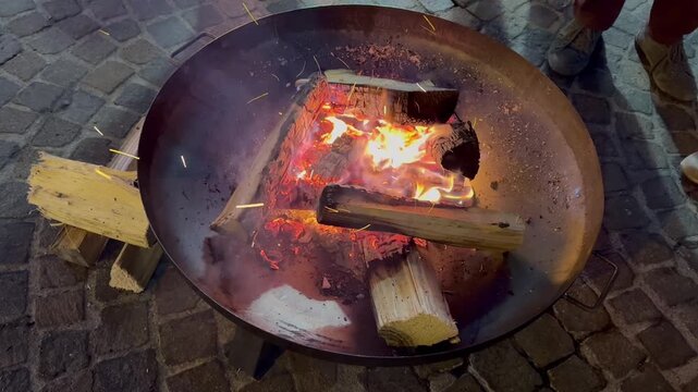 Mesmerizing campfire flames dancing in outdoor fire pit from overhead perspective