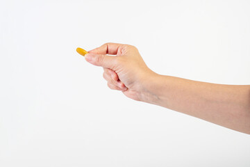Medicine or vitamins in hand on white background