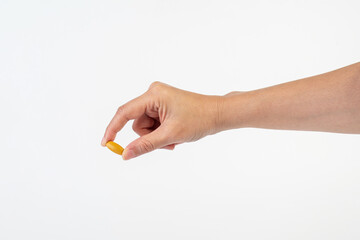 Medicine or vitamins in hand on white background