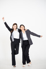 Two Asian women dressed in business attire posing on a clean white background, representing modern corporate roles, confident teamwork, and professional collaboration for office and company branding v