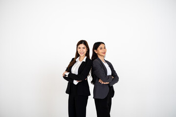Two Asian women dressed in business attire posing on a clean white background, representing modern corporate roles, confident teamwork, and professional collaboration for office and company branding v