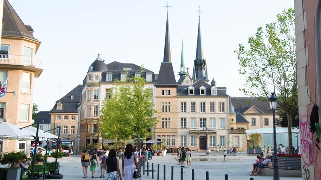 People Walking in Historic Luxembourg City Square at Dusk