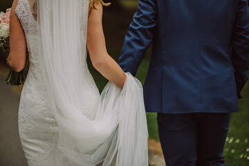 Bride and groom walking together holding hands wedding day photography