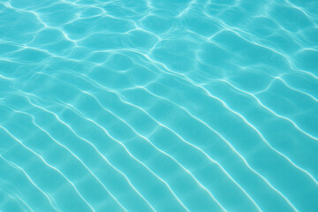 Clear turquoise water surface with calm, relaxing ripple patterns. summer sunlight reflection on swimming pool background