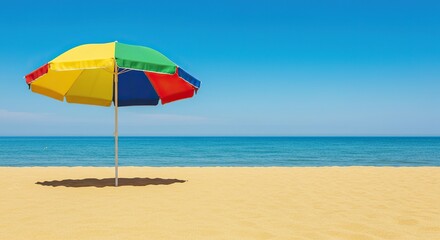 Vibrant beach umbrella firmly planted in golden sand, under clear blue sky, overlooking a tranquil ocean scene, perfect for summer relaxation ,pristine ,idyllic ,seaside