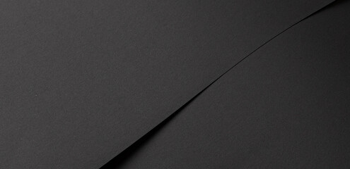 Dark black paper background with matte surface and fine material. Minimalistic premium space in chic