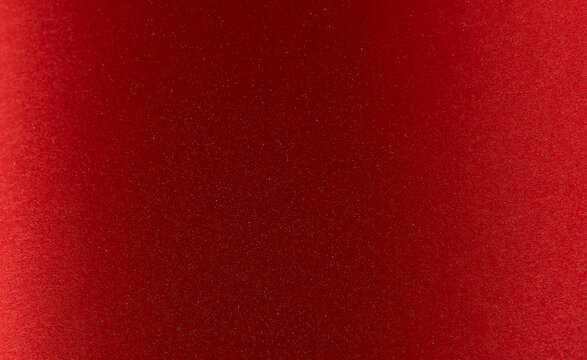 Colorful cherry red paper with matte surface and abstract design. Bright texture in minimalistic
