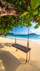 Swing hangs from lush tree over sandy beach; vibrant turquoise water & distant island backdrop on bright sunny day