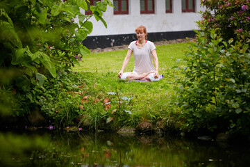 Lotus pose, meditation and peace with woman in park for zen exercise, mindfulness and spirituality. Mental health, healing aura and yoga with person in nature for holistic, awareness and calm