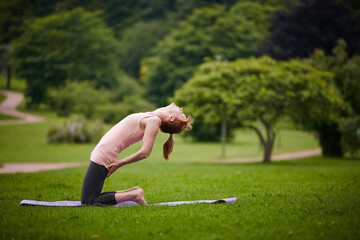 Park, woman and yoga in nature, flexible and stretching on mat to improve posture or self awareness. Yogi, outdoor and person with balance for camel pose, healthy and practice for wellness in forest