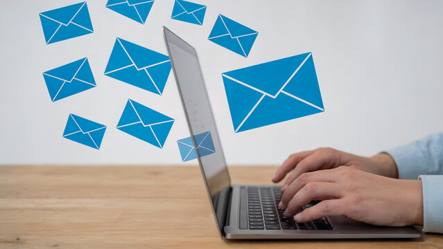Boost your business communication with email marketing, a professional sends emails from a laptop surrounded by digital envelopes for newsletters