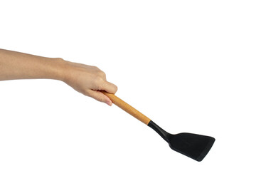 Hand with Black plastic kitchen spatula, kitchenware for cooking on transparent background.