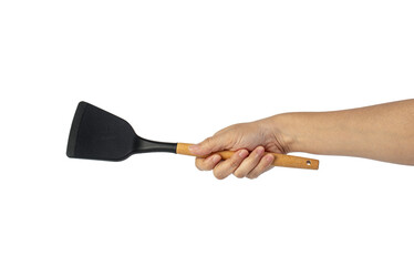 Hand with Black plastic kitchen spatula, kitchenware for cooking on transparent background.
